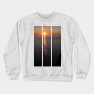 Wonderful landscapes in Norway. Nord-Norge. Beautiful scenery of a midnight sun sunset at Nordkapp (Cape North). Boat and globe on a cliff. Rippled sea and clear orange sky. (vertical) Crewneck Sweatshirt